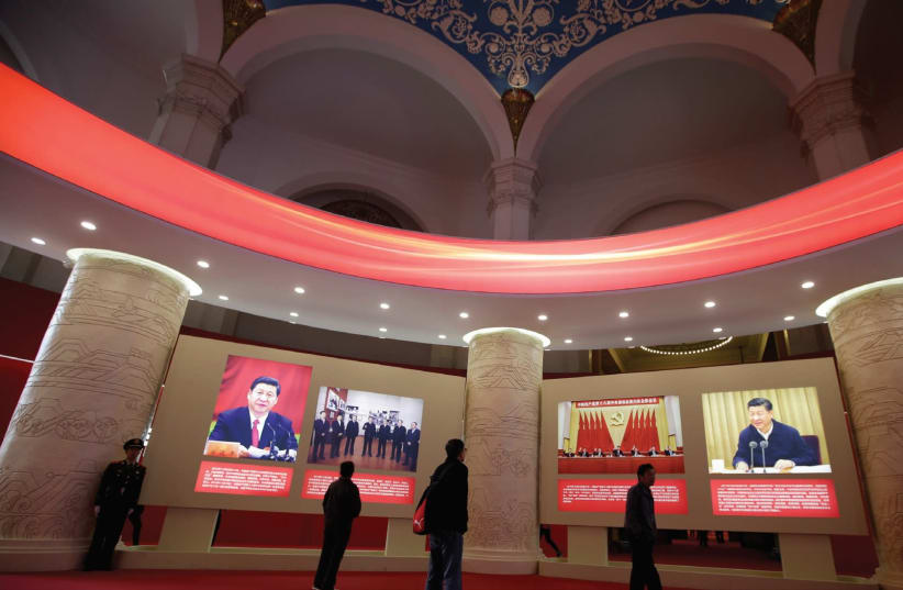 People visit an exhibition displaying China’s achievements over the past five years as part of the celebrations of the upcoming 19th National Congress of the Communist Party of China (CPC) at the Beijing Exhibition Center. (photo credit: REUTERS)