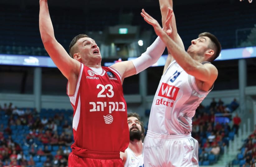 Hapoel Jerusalem center Alen Omic (left) scored 14 points last night, but it wasn’t enough to beat Aleksa Ilic and Buducnost, which left the Jerusalem Arena with an 86-81 victory in Eurocup action. (photo credit: DANNY MARON)