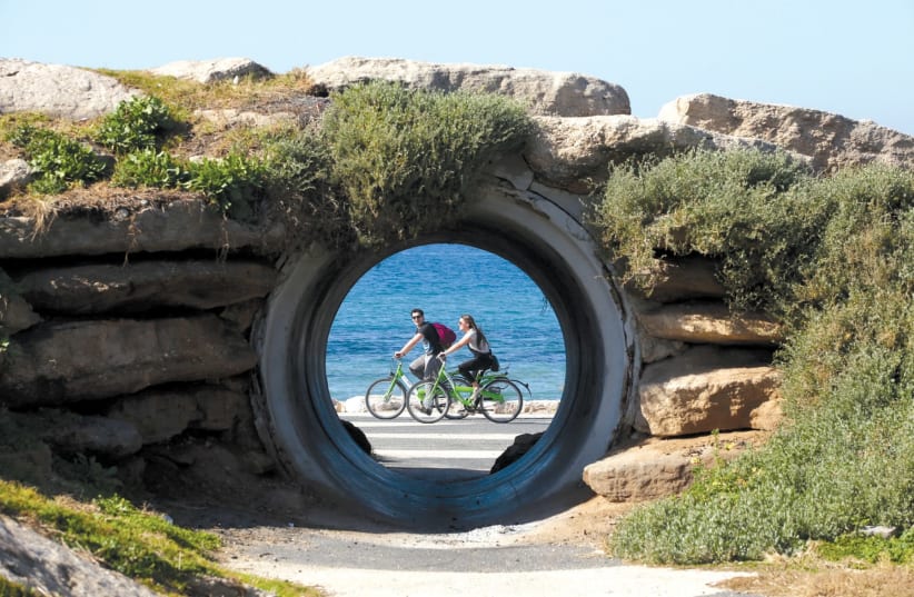 People enjoy a bike ride along Tel Aviv’s promenade. (photo credit: MARC ISRAEL SELLEM)