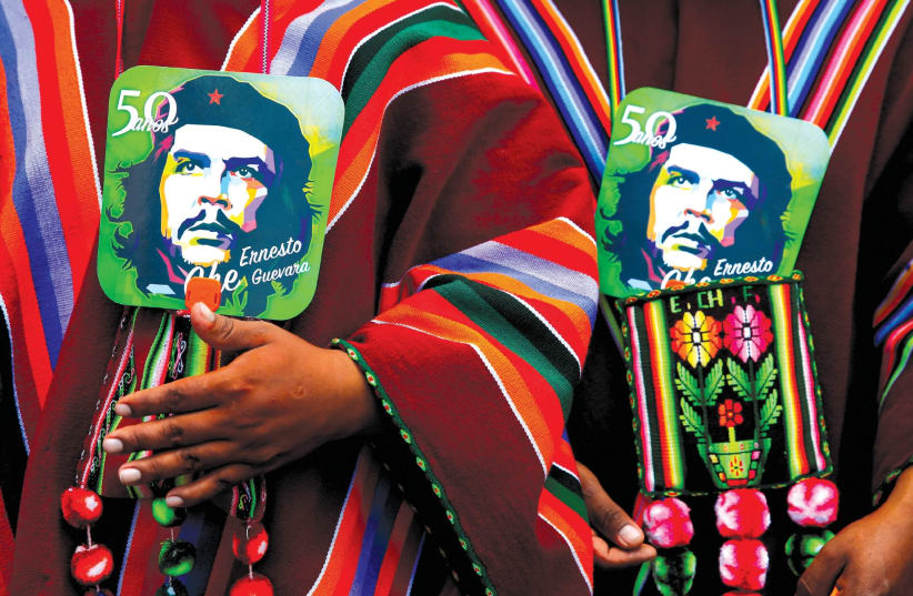 Images of Ernesto ‘Che’ Guevara at a ceremony commemorating the Argentinean revolutionary’s death in Bolivia. (photo credit: DAVID MERCADO/REUTERS)