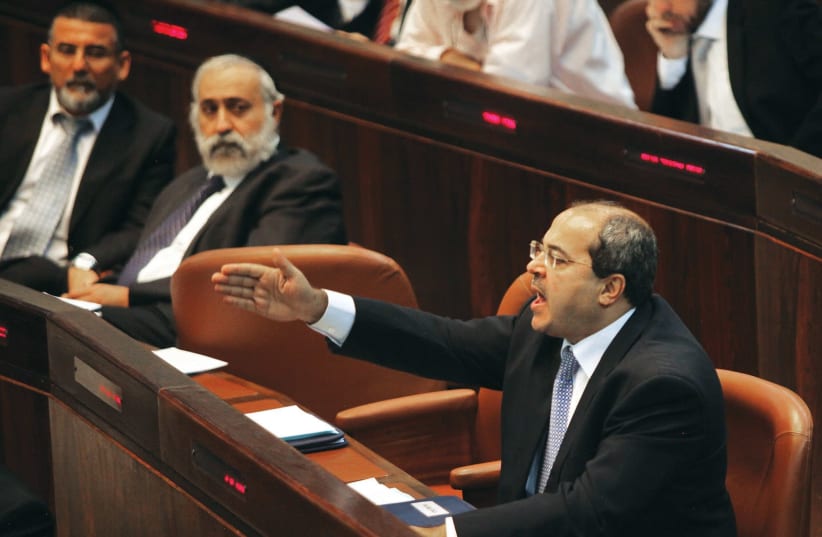 MK Ahmad Tibi (Joint List) was removed from the Knesset after shouting out that the Nation-State bill is racist. (photo credit: MARC ISRAEL SELLEM)