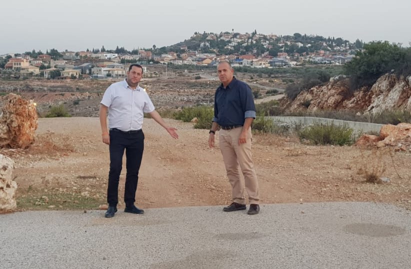 Samaria Regional Council head Yossi Dagan and Beit Aryeh-Ofarim Regional Council head Avi Naim point to the missing two kilometers of road.  (photo credit: ROI HADI)