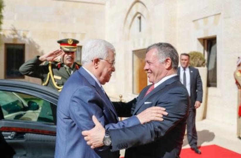 Palestinian Authority President Mahmoud Abbas and Jordanian King Abdullah greet each other in the courtyard of the Husseiniya Palace in Amman, October 22, 2017. (photo credit: WAFA)