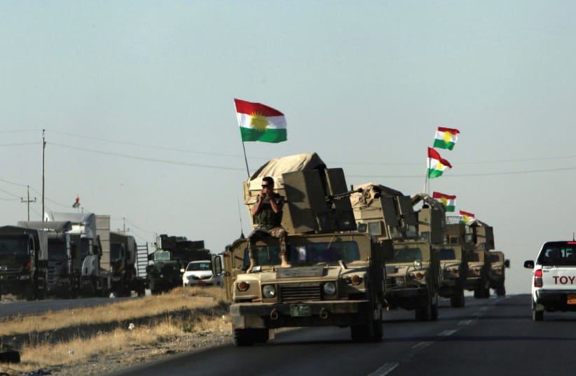 Kurdish Peshmerga vehicles rush to the front line at Altun Kupri after clashes with Iraqi security forces last Friday. (photo credit: REUTERS)