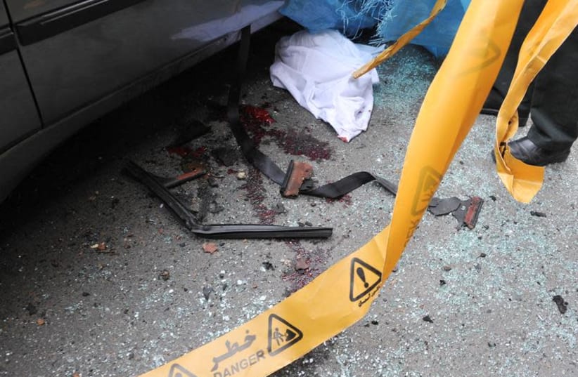  Bloodstains are seen next to the car belonging to Iranian nuclear scientist Mostafa Ahmadi-Roshan at a blast site outside a university in northern Tehran January 11, 2012. (photo credit: REUTERS/IIPA/SAJAD SAFARI/FILE PHOTO)