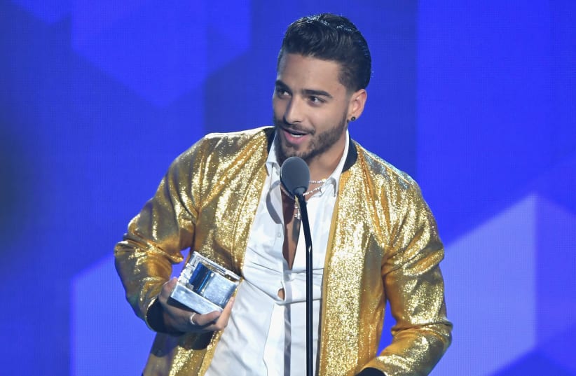 Maluma accepts an award on stage during Univision's "Premios Juventud" 2017 (photo credit: RODRIGO VARELA / GETTY IMAGES NORTH AMERICA / AFP)