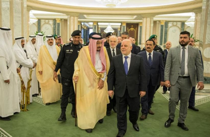 Saudi Arabia's King Salman bin Abdulaziz Al Saud and Iraqi Prime Minister Haider al-Abadi arrive for a meeting in Riyadh, Saudi Arabia October 22, 2017. (photo credit: SAUDI PRESS AGENCY/HANDOUT VIA REUTERS)