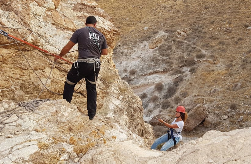 SCALING THE ROCKS in the Canaan Desert near Ma’ale Adumim. (photo credit: ELI PECHTER)