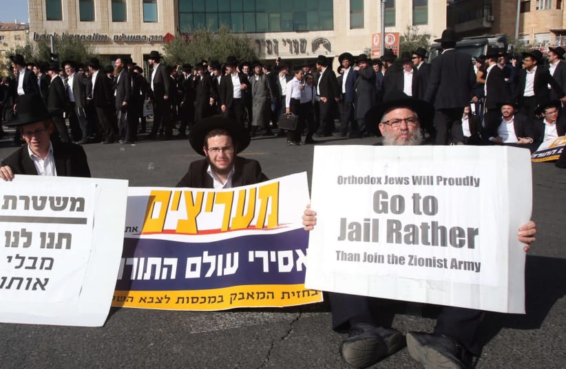 ULTRA-ORTHODOX protesters hold signs in Jerusalem during their ‘day of rage,’ declared to protest the arrest of two draft-dodging yeshiva students. (photo credit: MARC ISRAEL SELLEM/THE JERUSALEM POST)