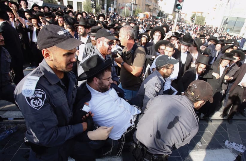 POLICE APPREHEND a man during last week’s ‘day of rage’ protest in Jerusalem. (photo credit: MARC ISRAEL SELLEM/THE JERUSALEM POST)