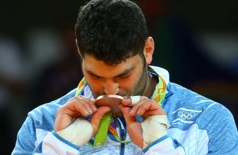 Or Sasson of Israel kisses his medal at the 2016 Rio Olympics (photo credit: REUTERS)