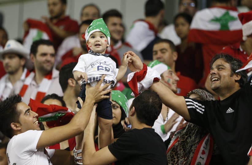Fans of Lebanon cheer for their team during their 2014 World Cup qualifying soccer match against Qatar in Doha, November 14, 2012. (photo credit: REUTERS)