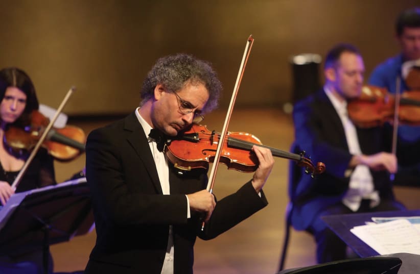 Matan Dagan plays a violin, which was lost in France during the Holocaust (photo credit: MARC ISRAEL SELLEM/THE JERUSALEM POST)