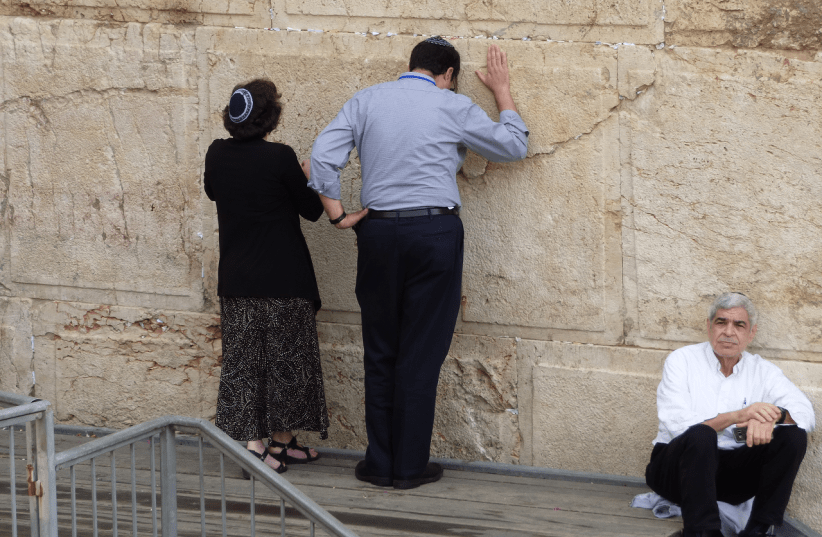 A man and woman pray at the egalitarian section of the Western Wall (photo credit: DAVID SHECHTER FOR THE JEWISH AGENCY FOR ISRAEL)