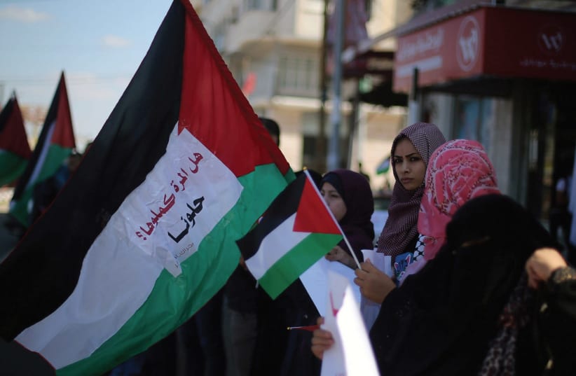 WOMEN WAVE flags celebrating Palestinian unity.  (photo credit: REUTERS)