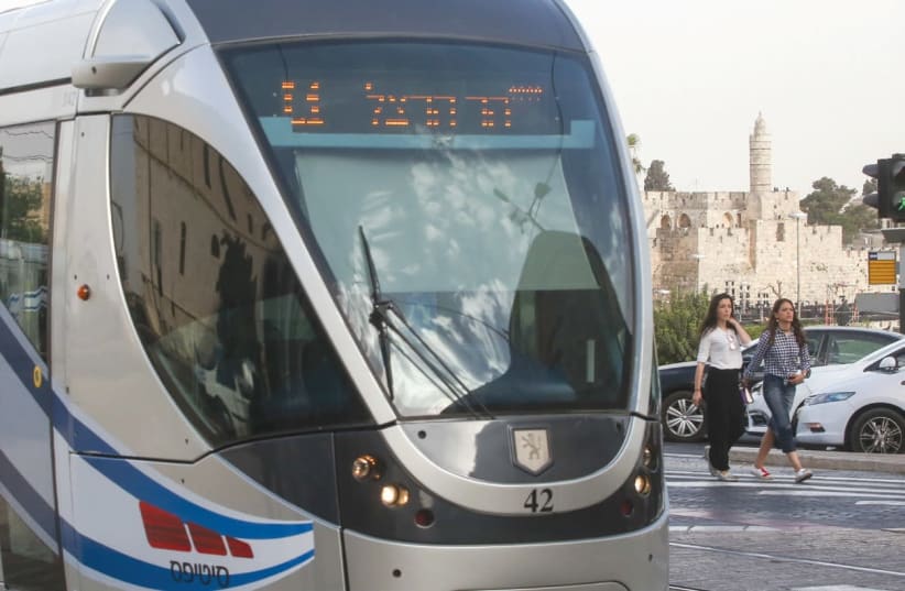 The Jerusalem light rail celebrated the 50th anniversary of the capital city’s reunification last summer by decorating its trains with Israeli flags and banners. (photo credit: MARC ISRAEL SELLEM/THE JERUSALEM POST)