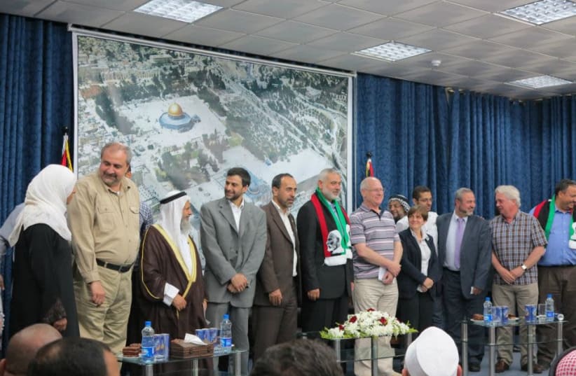 PSC Chairman Hugh Lanning (second from the right) standing with Hamas Cheif Ismail Haniyeh (center). (photo credit: COURTESY MINISTRY OF STRATEGIC AFFAIRS)