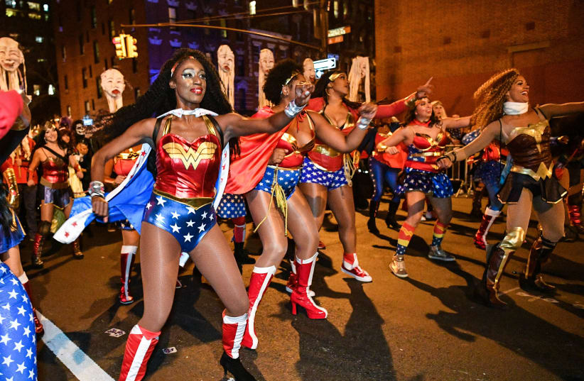 Halloween revelers dressed as Wonder Woman attend the Annual Village Halloween Parade on October 31, 2017 in New York City (photo credit: DIA DIPASUPIL / GETTY IMAGES NORTH AMERICA / AFP)