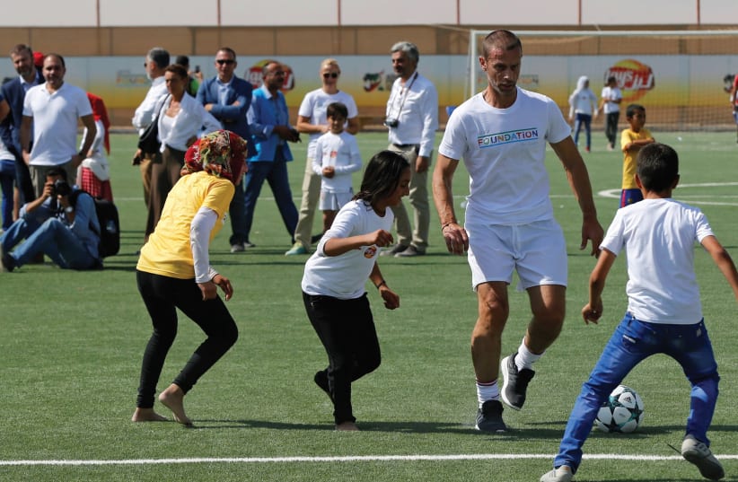 ‘EVERY WEEK on soccer fields across the country, Jews and Arabs stand shoulder to shoulder, striving for victory in a spirit of mutual respect and coexistence.’ (photo credit: REUTERS)