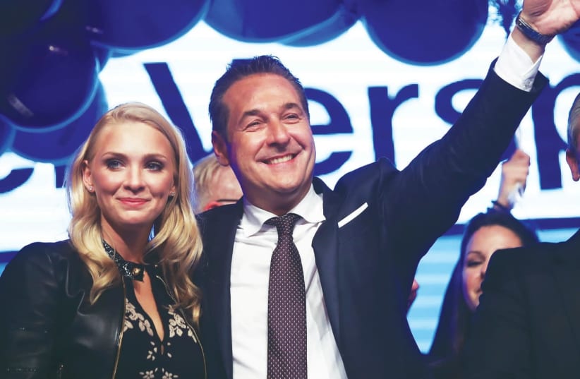 Heinz-Christian Strache, the head of the far-right Freedom Party, celebrates in Vienna with his wife, Phillipa Beck, after Austria's general election (photo credit: MICHAEL DALDER/REUTERS)