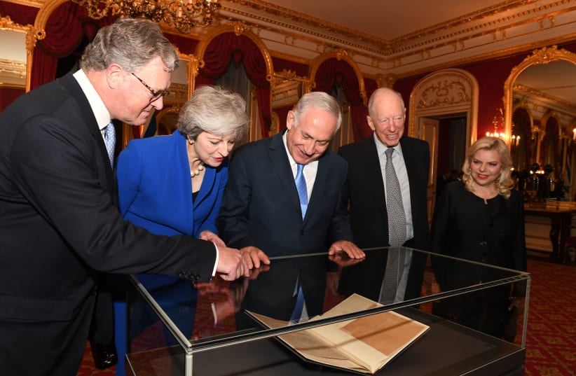 Prime Minister Benjamin Netanyahu and his wife Sara look at the original Balfour Declaration with British Prime Minister Theresa May, Lord Balfour and Lord Rothschild (photo credit: KOBI GIDEON/GPO)