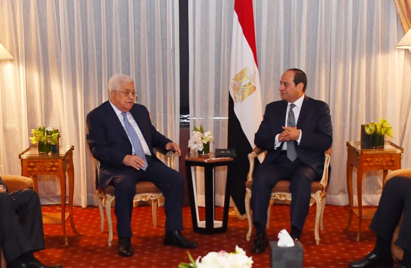 Egyptian President Abdel Fattah al-Sisi speaks with Palestinian President Mahmoud Abbas during their meeting as part of an effort to revive the Middle East peace process ahead of the United Nations General Assembly in New York, US, September 19, 2017 (photo credit: THE EGYPTIAN PRESIDENCY/HANDOUT VIA REUTERS)