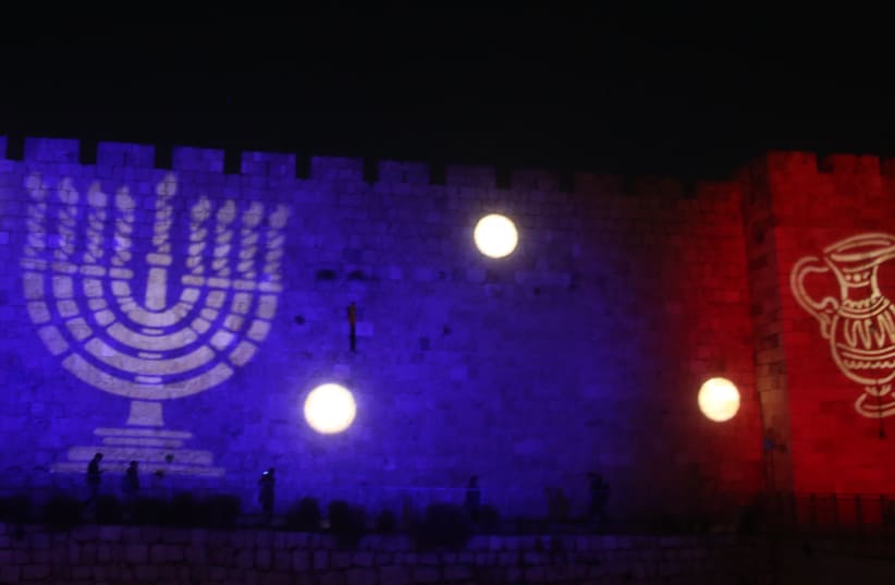 Hanukkah images are displayed on the walls of the Old City in Jerusalem (photo credit: MARC ISRAEL SELLEM)