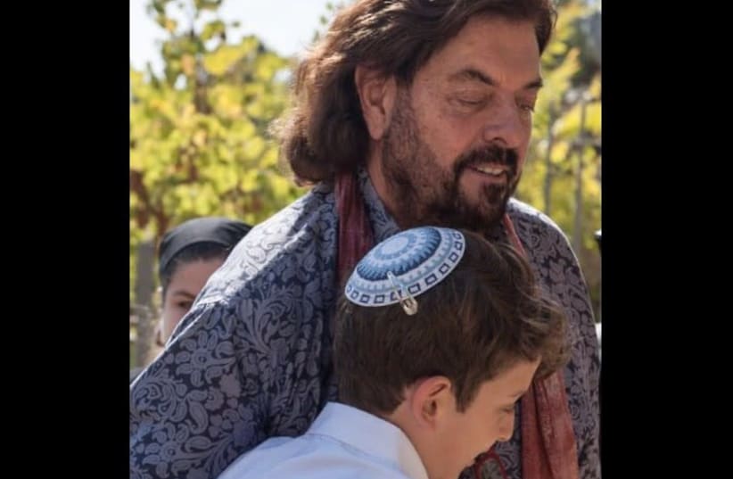 Alan Parsons embraces 13-year-old Tal Erez outside the Yemin Moshe synagogue this week at his bar mitzva (photo credit: MICHAEL SHVADRON)