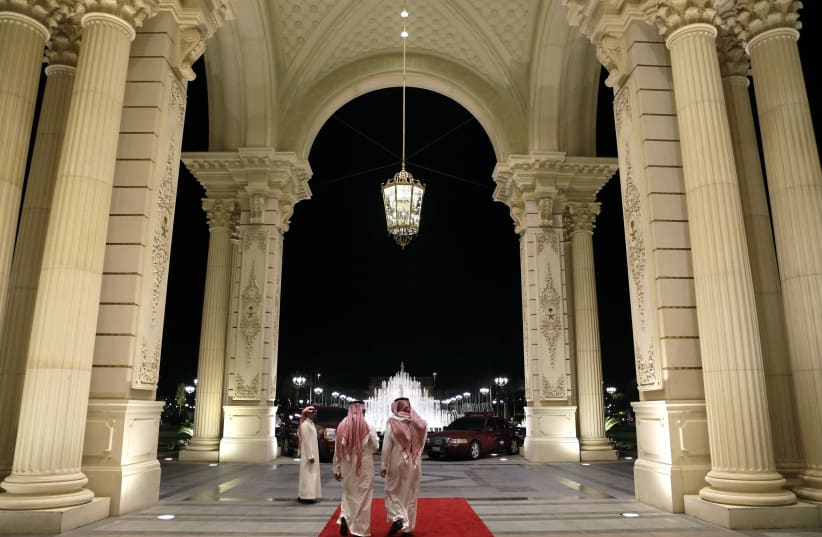 Saudi men walk at the entrance to the Ritz-Carlton Hotel. (photo credit: REUTERS)