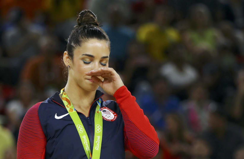 Aly Raisman receives a silver medal at the 2016 Olympics in Rio de Janeiro, Brazil. (photo credit: REUTERS)