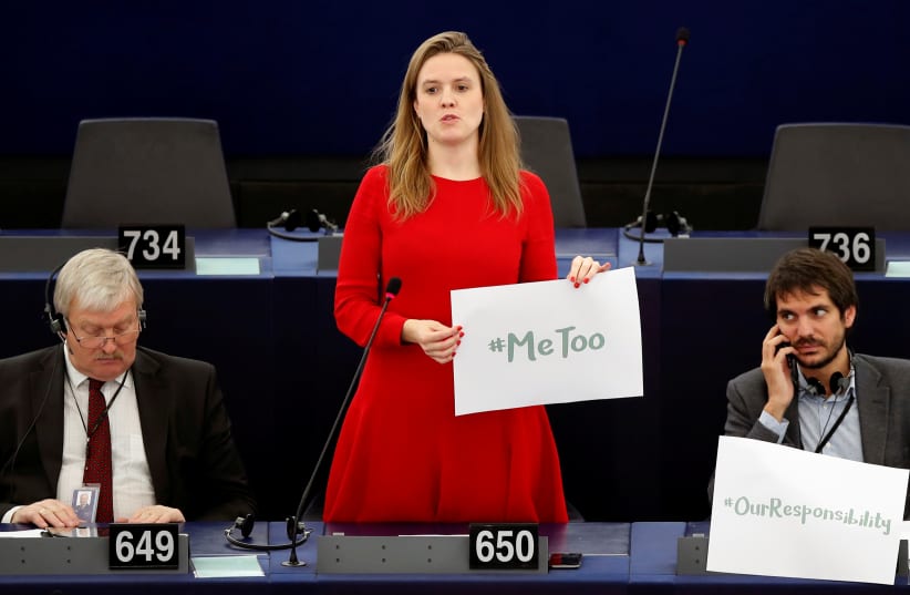 European Parliament member Terry Reintke (C) holds a placard with the hashtag "MeToo" during a debate to discuss preventive measures against sexual harassment and abuse in the EU at the European Parliament in Strasbourg, France, October 25, 2017. (photo credit: REUTERS/CHRISTIAN HARTMANN)
