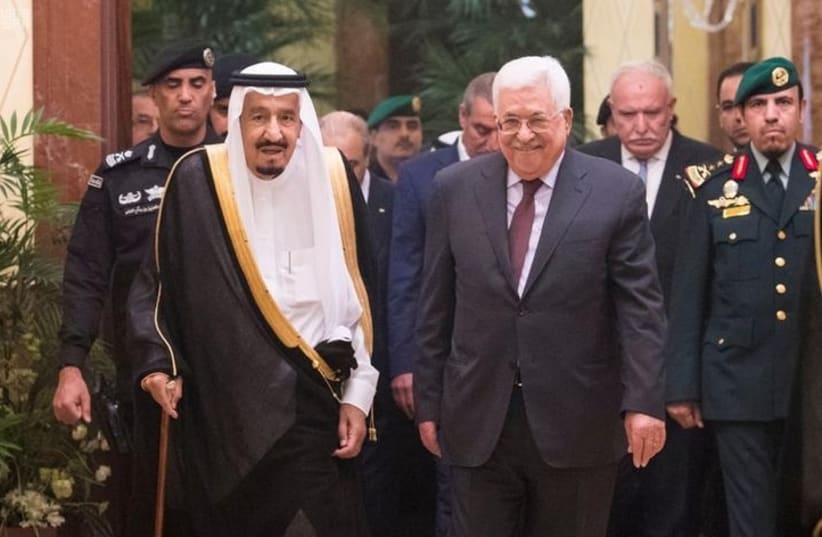 Saudi Arabia's King Salman bin Abdulaziz Al Saud walks with Palestinian President Mahmoud Abbas during a reception ceremony in Riyadh, Saudi Arabia November 7, 2017 (photo credit: SAUDI PRESS AGENCY/HANDOUT VIA REUTERS)