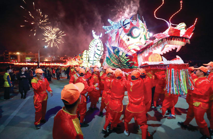 PEOPLE PERFORM with a long dragon lantern as they celebrate the Chinese New Year, in Longyan, Fujian province, last February (photo credit: REUTERS)
