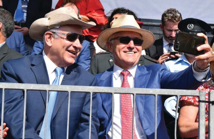 Sporting Australian bush hats, Australian Prime Minister Malcolm Turnball takes a selfie with Prime Minister Benjamin Netanyahu at the reenactment of the Battle of Beersheba on October 31 (photo credit: GPO/AMOS BEN GERSHOM)