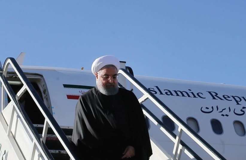 IRANIAN PRESIDENT Hassan Rouhani walks down aircraft steps as he arrives at Kermanshah near the areas worst hit by the earthquake. (photo credit: REUTERS)