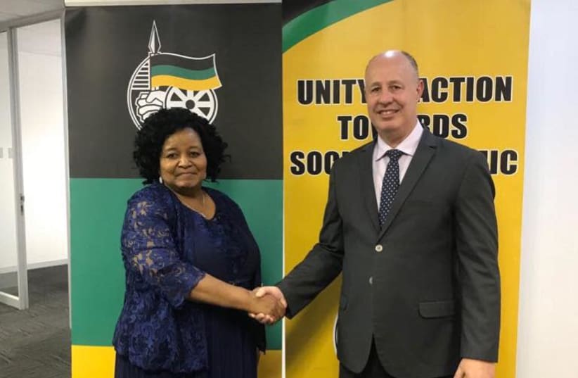 Regional Cooperation Minister Tzachi Hanegbi shakes hands with the ANC's International Relations Subcommittee chairwoman Edna Molewa during a meeting in South Africa last week. (Facebook) (photo credit: FACEBOOK)