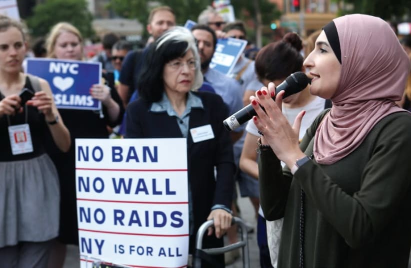 Activist Linda Sarsour speaks at a June protest in New York City against US President Donald Trump’s limited travel ban (photo credit: REUTERS/JOE PENNEY)