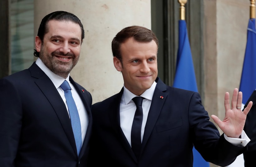 French President Emmanuel Macron and Saad al-Hariri, who announced his resignation as Lebanon's prime minister while on a visit to Saudi Arabia, react on the steps of the Elysee Palace in Paris, France, November 18, 2017.  (photo credit: BENOIT TESSIER /REUTERS)