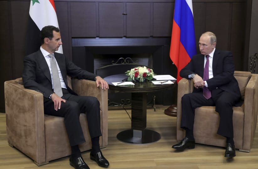 Russian President Vladimir Putin meets with Syrian President Bashar Assad in Sochi, Russia, November 2017 (photo credit: SPUTNIK PHOTO AGENCY / REUTERS)