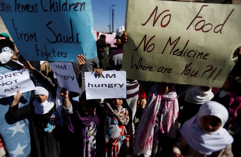Yemeni children protest the Saudi-led coalition's blockade of their country, November 2017 (photo credit: REUTERS/KHALED ABDULLAH)