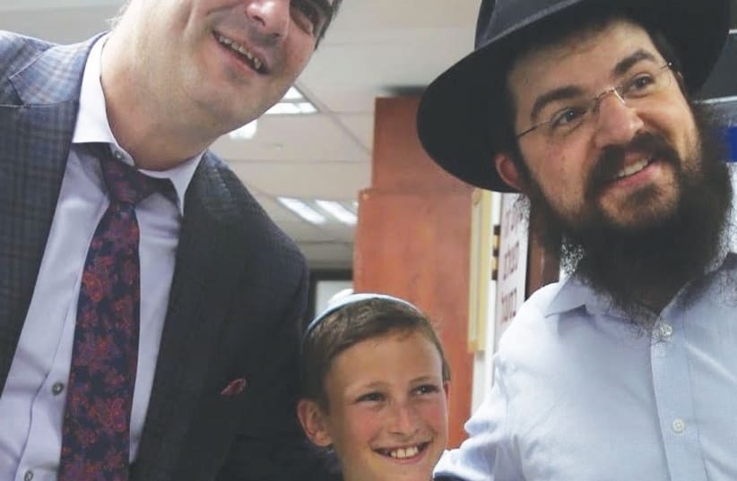 Liran Nathan poses for a photograph with Eli Beer (left) and Benny Friedman (right) (photo credit: BENITA LEVIN)
