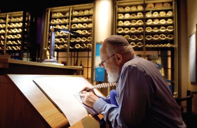 RABBI ELIEZER ADAM works on the Sefer Torah at Washington’s Museum of the Bible last week (photo credit: KEVIN LAMARQUE/REUTERS)