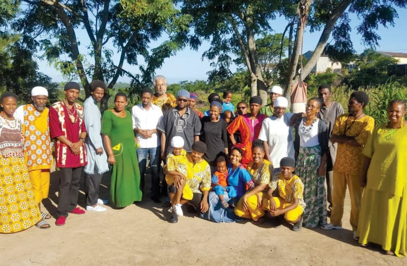 MEMBERS OF the AHI community in East London, South Africa, with Dimona community leader, Minister Ahmadiel Ben Yehuda (the tallest) in the center. (photo credit: Courtesy)