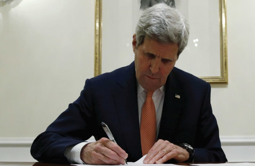 JOHN KERRY inking the Joint Comprehensive Plan of Action (JCPOA) in 2015.  (photo credit: REUTERS)