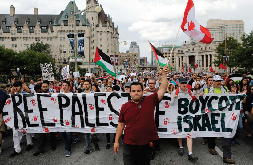 PRO-PALESTINIAN PROTESTERS take part in a demonstration against Israel’s military action in the Gaza Strip, in Ottawa. (photo credit: REUTERS)