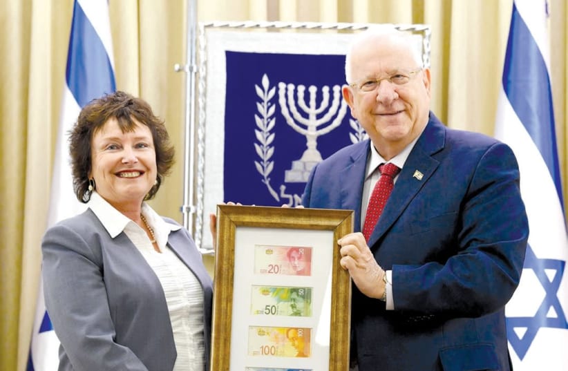 BANK OF ISRAEL Governor Karnit Flug delivers the new banknote series to President Reuven Rivlin at the President’s Residence on Wednesday. (photo credit: MARK NEYMAN/GPO)