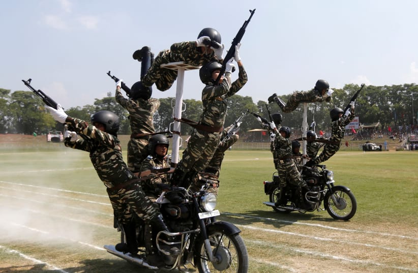 Indian policewomen perform a stunt on their motorbikes (photo credit: REUTERS/DANISH ISMAIL)