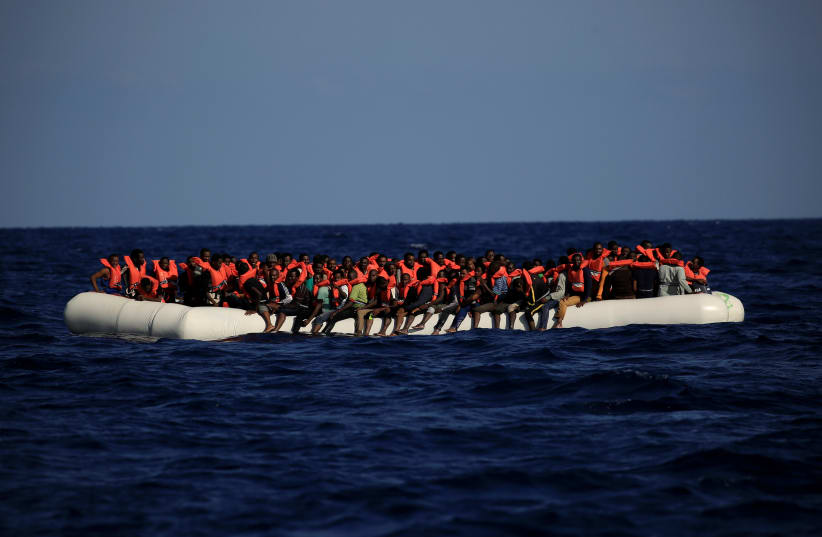 An overcrowded dinghy with migrants from different African countries is seen during a rescue operation off the Libyan coast in the Mediterranean Sea September 21, 2016. (photo credit: REUTERS)