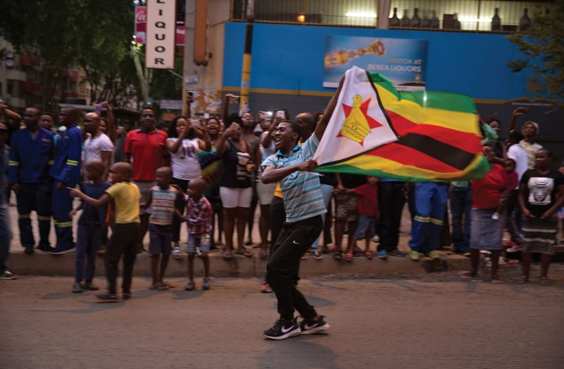 ZIMBABWEANS CELEBRATE the resignation of Robert Mugabe (photo credit: REUTERS)