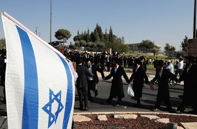 ULTRA-ORTHODOX JEWS dance as they protest outside the Knesset last month. (photo credit: REUTERS)